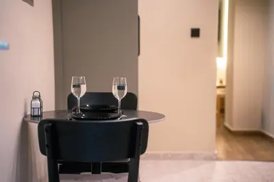 a table with two glasses of wine on it at Sweet Dispotition-Modern ground flat next to metro in Athens