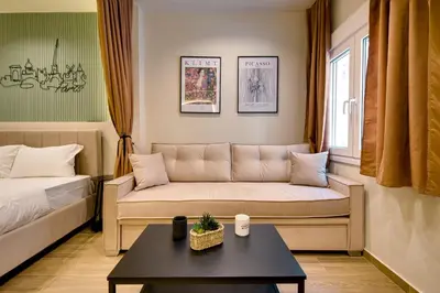 a living room with a couch and a table at Sweet Dispotition-Modern ground flat next to metro in Athens