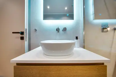a bathroom with a white sink and a shower at Sweet Dispotition-Modern ground flat next to metro in Athens