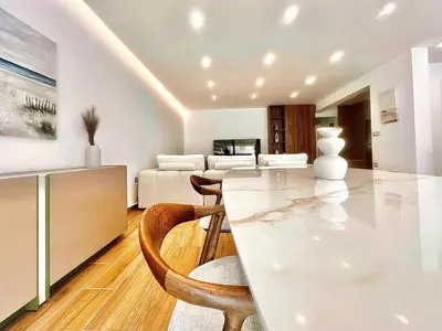a living room with a white table and chairs at Sealine Spacious Apartment in Athens