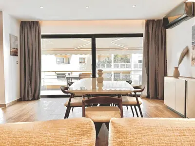 a dining room with a table and chairs at Sealine Spacious Apartment in Athens