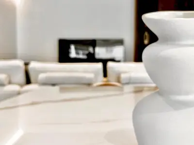 a white vase sitting on a table in a living room at Sealine Spacious Apartment in Athens