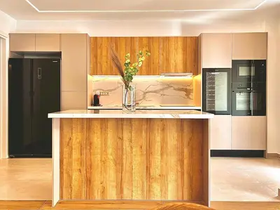 a kitchen with wooden cabinets and a vase of flowers on a counter at Sealine Spacious Apartment in Athens
