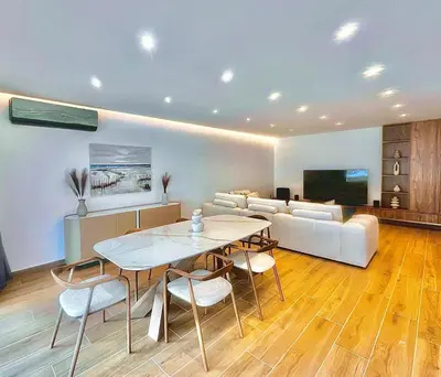 a living room with a table and a couch at Sealine Spacious Apartment in Athens