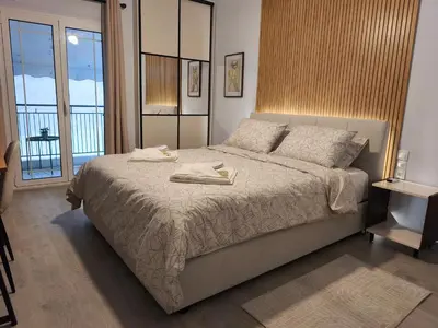 a bedroom with a bed with two towels on it at Urban Piraeus Studio 200m from Neo Faliro Station in Piraeus
