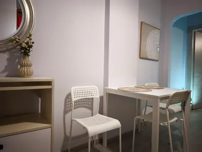 a room with a table and two chairs and a mirror at Urban Piraeus Studio 200m from Neo Faliro Station in Piraeus
