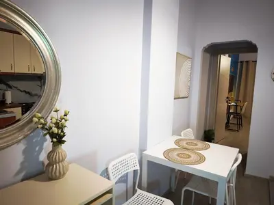 a white table and chairs in a room with a mirror at Urban Piraeus Studio 200m from Neo Faliro Station in Piraeus