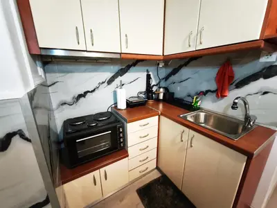 a small kitchen with a stove and a sink at Urban Piraeus Studio 200m from Neo Faliro Station in Piraeus