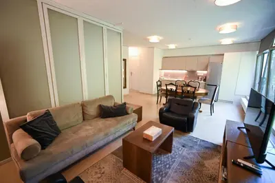 a living room with a couch and a table at Tsakalof Luxe by Zeus Suites in Athens