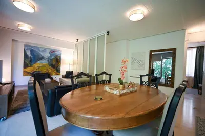 a living room with a table and a couch at Tsakalof Luxe by Zeus Suites in Athens