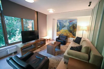 a living room with a couch and a flat screen tv at Tsakalof Luxe by Zeus Suites in Athens