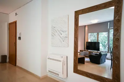a mirror on a wall in a living room at Tsakalof Luxe by Zeus Suites in Athens