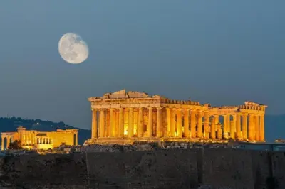 a large building with a full moon in the sky at Acropolis Center Rooms in Athens