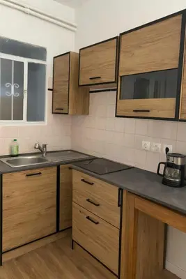 a kitchen with wooden cabinets and a sink at Metro blue line Megaro Mousikis Αpartment in Athens
