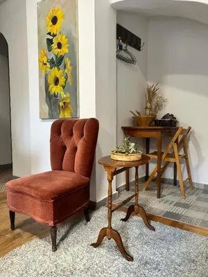 a living room with a chair and a table at Metro blue line Megaro Mousikis Αpartment in Athens