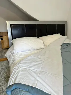 a large white bed with a black head board at Metro blue line Megaro Mousikis Αpartment in Athens