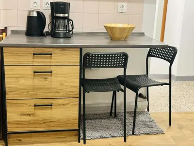 a kitchen counter with two chairs and a desk at Metro blue line Megaro Mousikis Αpartment in Athens