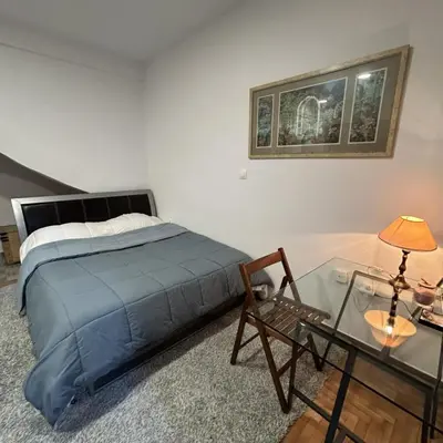 a bedroom with a bed and a glass table at Metro blue line Megaro Mousikis Αpartment in Athens