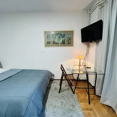a bedroom with a bed and a glass table at Metro blue line Megaro Mousikis Αpartment in Athens