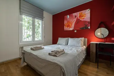 a bedroom with a bed with two towels on it at The 'it' Pagrati Hideout in Athens