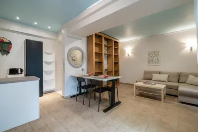 a living room with a table and a couch at The 'it' Pagrati Hideout in Athens