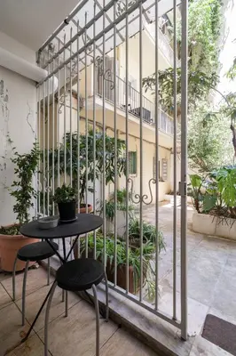 a table and two chairs in front of a building at The 'it' Pagrati Hideout in Athens
