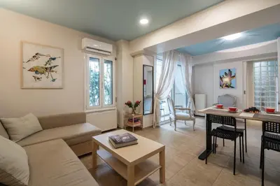 a living room with a couch and a table at The 'it' Pagrati Hideout in Athens