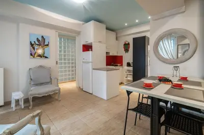 a kitchen and living room with a table and a chair at The 'it' Pagrati Hideout in Athens
