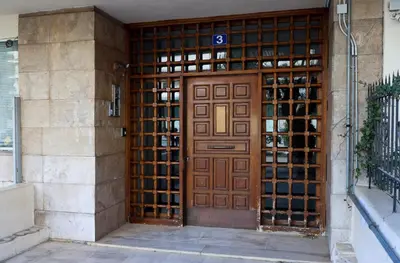 a wooden door with a sign on it at Best House Erato Neo Faliro Piraeus in Piraeus