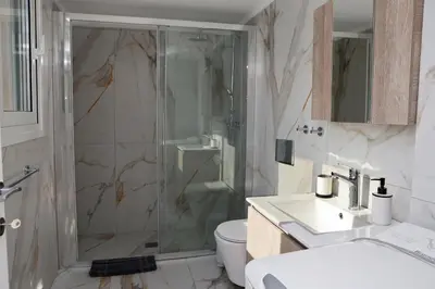 a bathroom with a shower and a toilet and a sink at Best House Erato Neo Faliro Piraeus in Piraeus