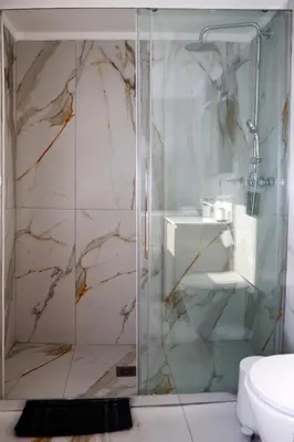 a bathroom with a glass shower with a sink at Best House Erato Neo Faliro Piraeus in Piraeus