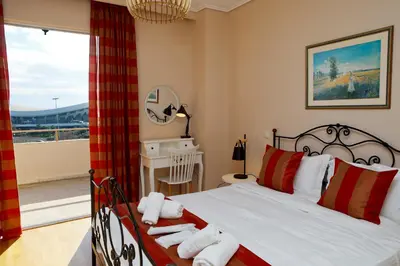 a bedroom with a bed with towels on it at Best House Penelope Neo Faliro Piraeus in Piraeus