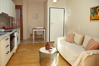 a living room with a couch and a table at Best House Penelope Neo Faliro Piraeus in Piraeus