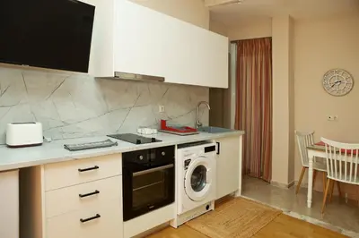 a kitchen with a washer and a washing machine at Best House Penelope Neo Faliro Piraeus in Piraeus