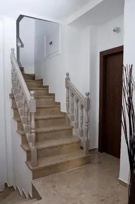 a staircase in a house with a wooden door at Best House Penelope Neo Faliro Piraeus in Piraeus