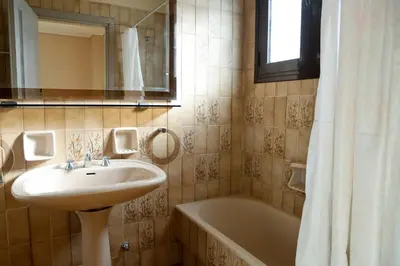a bathroom with a sink and a bath tub at Best House Penelope Neo Faliro Piraeus in Piraeus