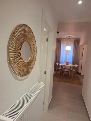 a mirror on the wall of a room with a table at Hidden Paradise at Kolonaki in Athens
