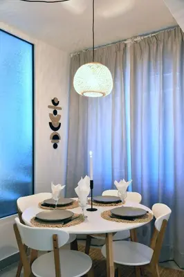 a dining room with a table with chairs and a candle at Hidden Paradise at Kolonaki in Athens