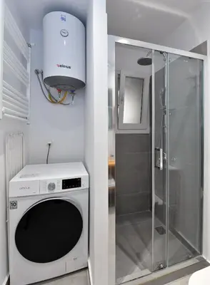 a washing machine in a bathroom with a shower at Hidden Paradise at Kolonaki in Athens