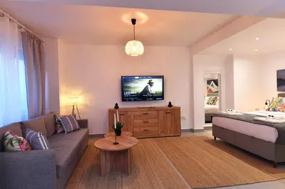 a living room with a couch and a flat screen tv at Hidden Paradise at Kolonaki in Athens