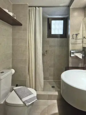 a bathroom with a tub and a toilet and a sink at Sea Breeze near Vouliagmeni in Athens