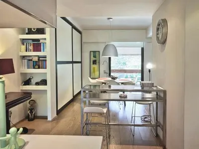 a dining room with a glass table and chairs at Sea Breeze near Vouliagmeni in Athens