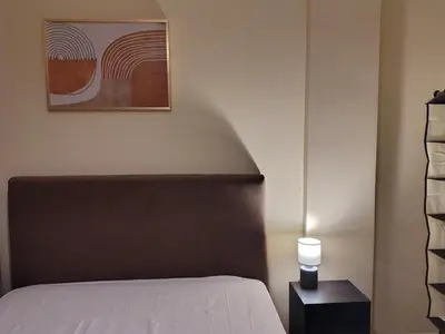 a bedroom with a bed and a picture on the wall at Wonderful Central Apartment in Athens
