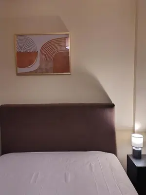 a bedroom with a bed and a painting on the wall at Wonderful Central Apartment in Athens