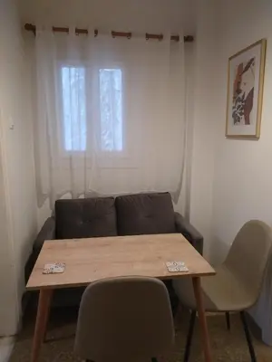 a living room with a table and a couch at Wonderful Central Apartment in Athens