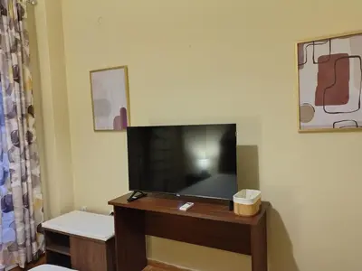 a living room with a flat screen tv on a wall at Wonderful Central Apartment in Athens