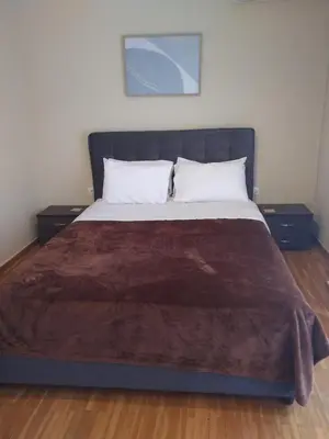a bedroom with a large bed with two night stands at Wonderful Central Apartment in Athens