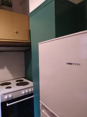 a kitchen with a white stove and a refrigerator at Wonderful Central Apartment in Athens