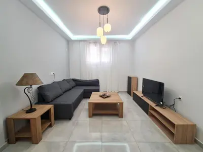 a living room with a couch and a tv at Family apartment at the center of Piraeus in Piraeus