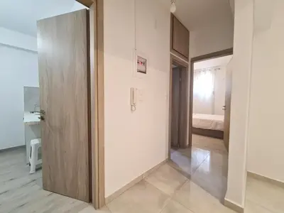 a hallway with a door leading to a bedroom at Family apartment at the center of Piraeus in Piraeus